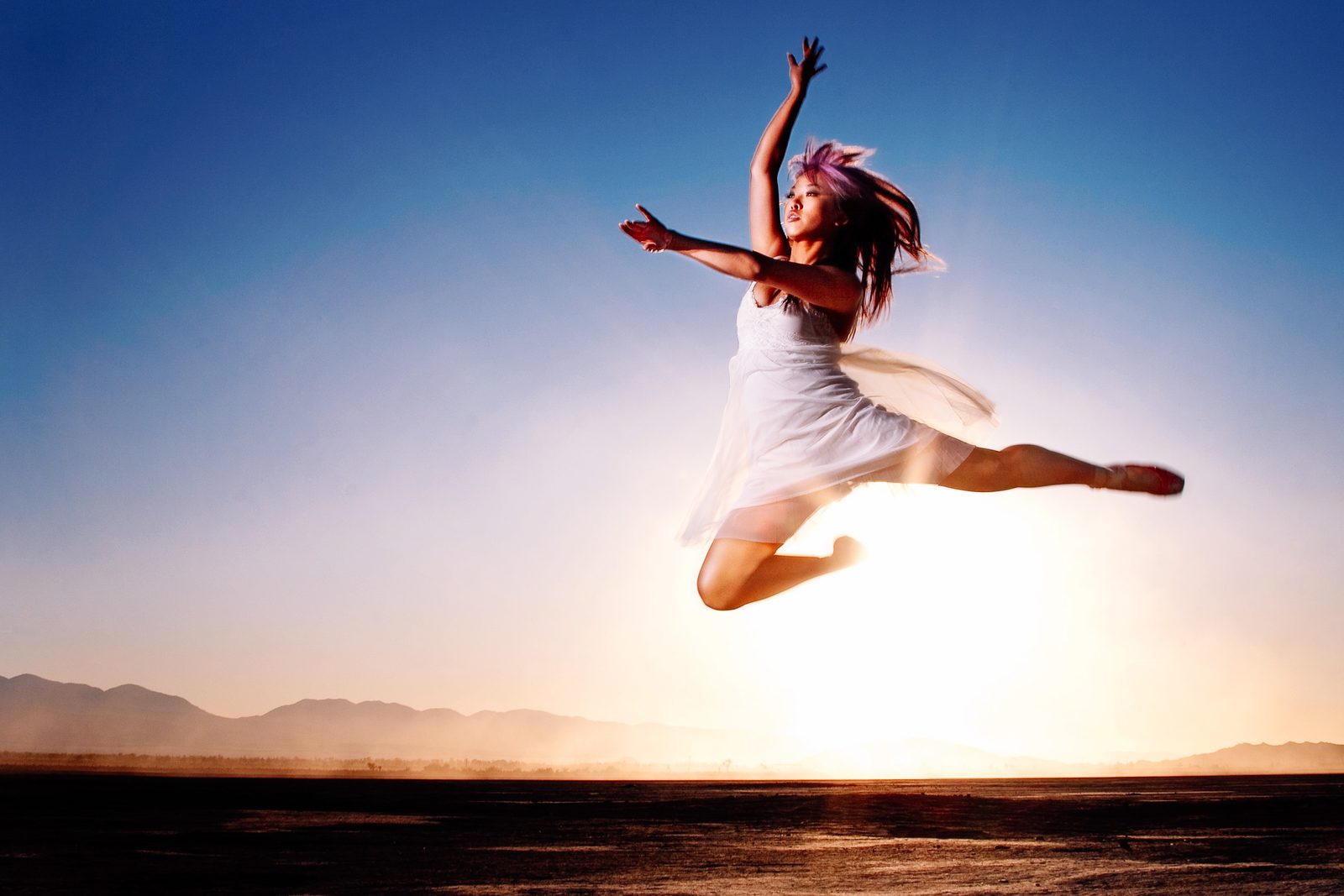 Dancer leaping against a desert sunset — Photography by Luis Aguirre