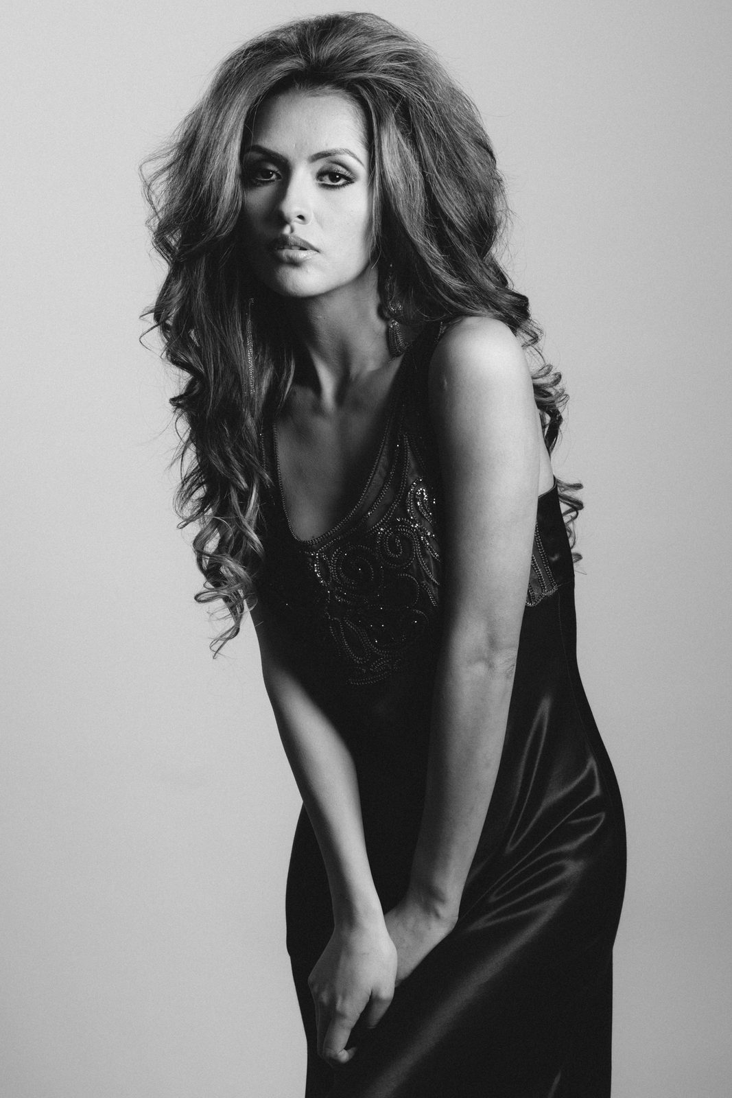 Black-and-white studio portrait in a slip dress
